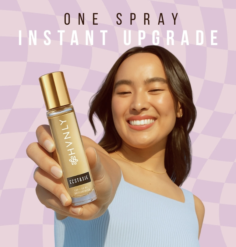 Woman holding a bottle of 'Hvnly's Ecstasie' spray with a colorful geometric background