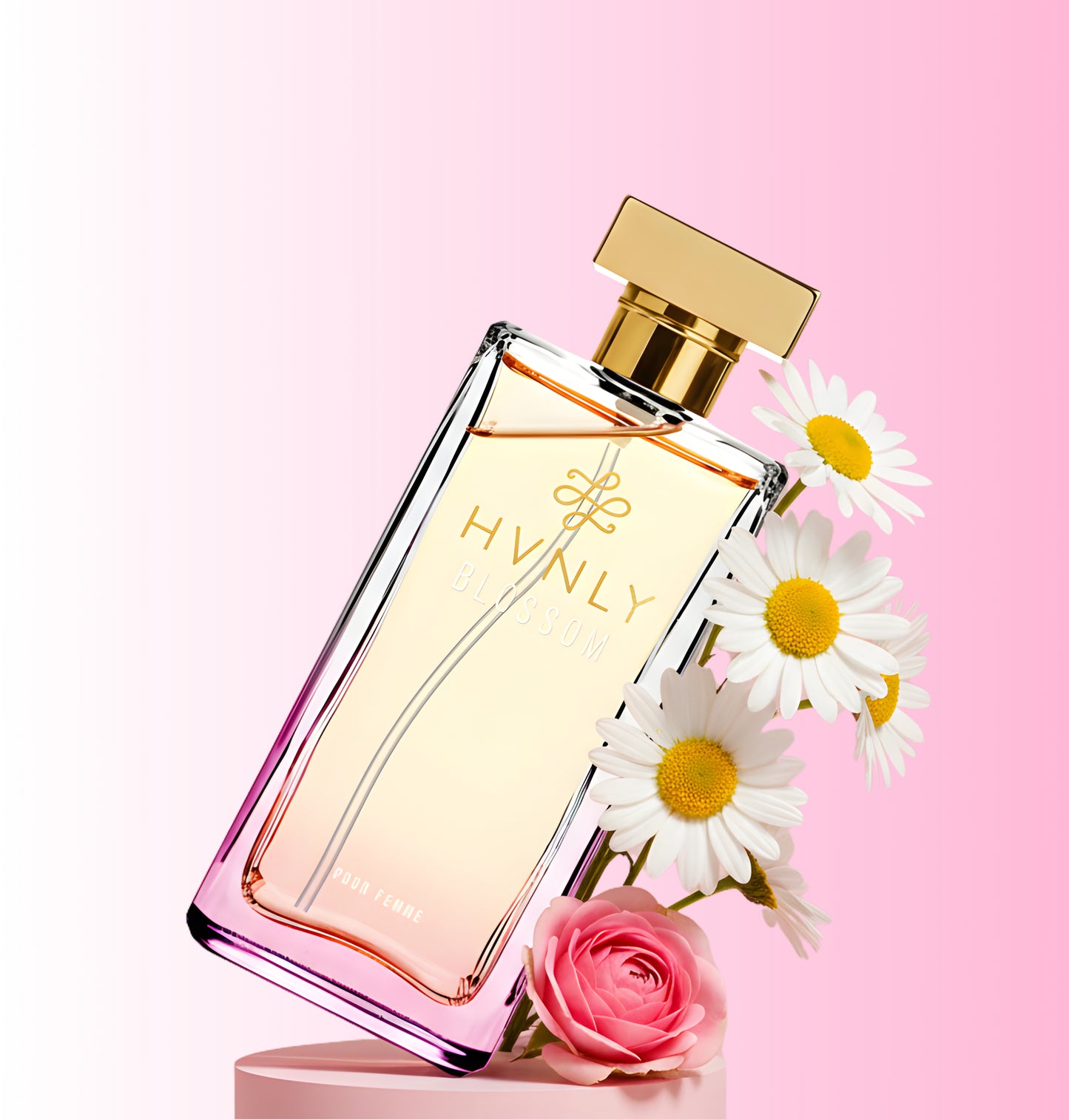 Blossom Perfume bottle with gold cap and 'HVNLY' branding on a pink background with flowers.