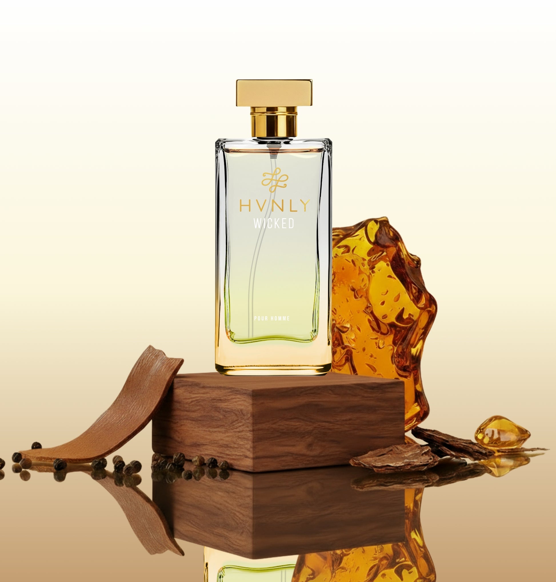 Perfume bottle with gold cap and 'HVNLY' branding on a reflective surface with amber glass and wooden elements.