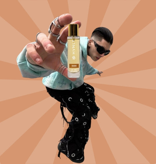 Person holding a HVNLY's Oudh  perfume bottle with a sunburst pattern background