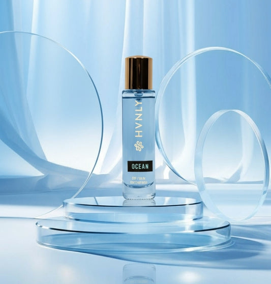 HVINLY Ocean bottle on a clear stand with a blue curtain background