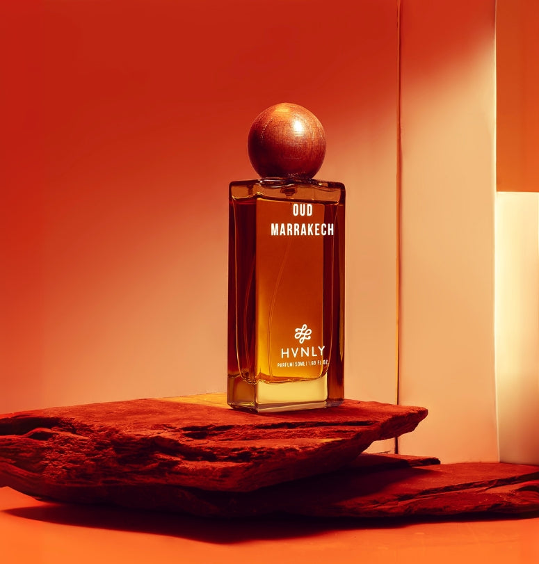Perfume bottle labeled 'Oud Marrakech' by HVNLY on a red background showcasing the perfume aesthetics