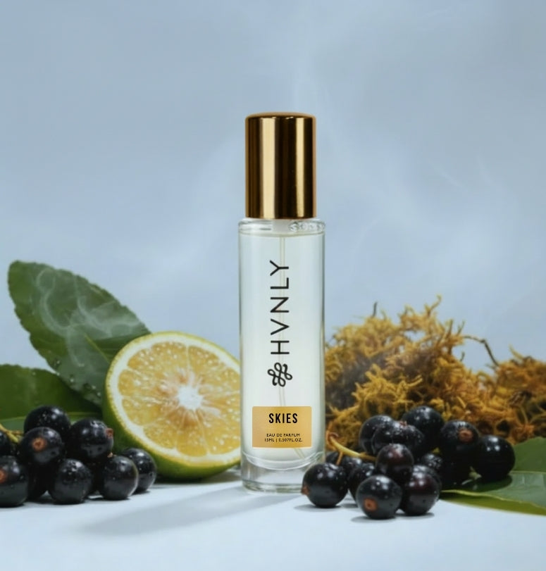 Perfume bottle labeled 'HVNLY' with fruits and leaves on a light blue background showing notes of the perfume