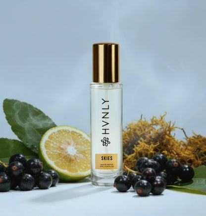 Perfume bottle labeled 'HVNLY' with fruits and leaves on a light blue background showing notes of the perfume