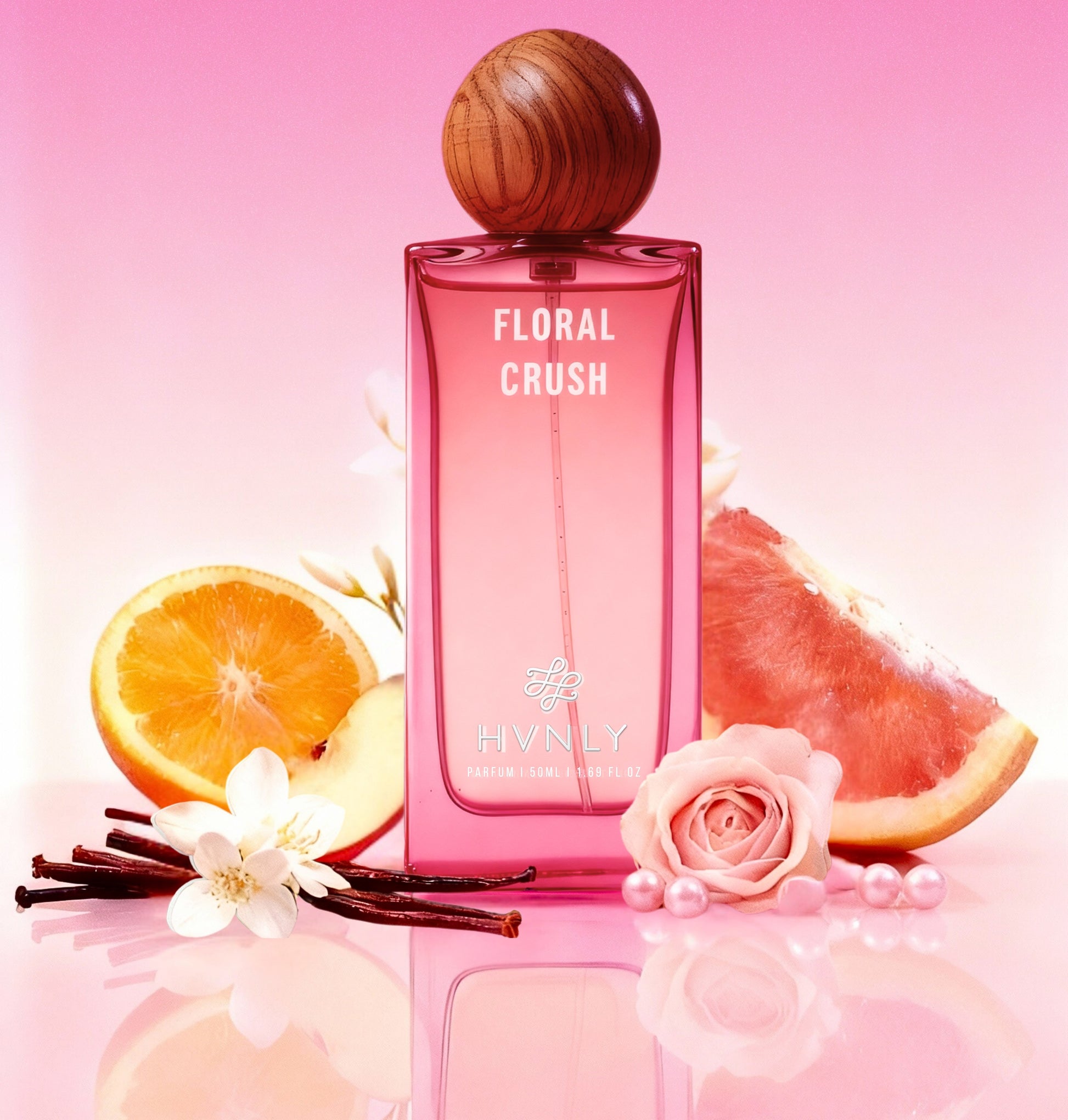 Pink 'Floral Crush' perfume bottle by HVNLY, with fruit and flowers on a pink background
