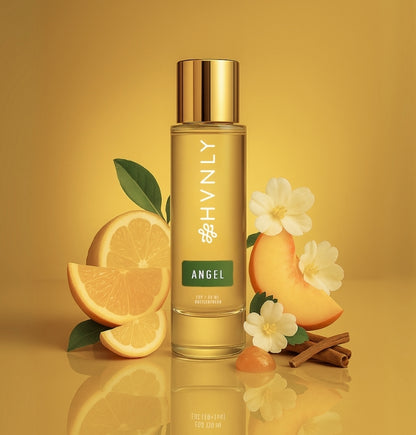 Gold bottle of HVNLY Angel perfume depicting colorful imagery of its ingredients.