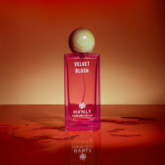 Perfume bottle labeled 'Velvet Blush' by HVNLY on a red background showing the sensory effect of the perfume.