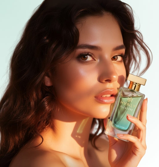 Woman holding a perfume bottle with a light blue background