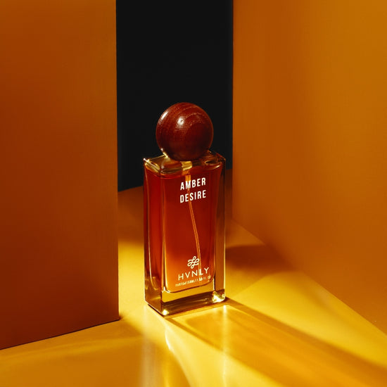 Sliding shot of Amber Desire perfume by Hvnly showcasing the top, middle and base notes of the perfume in the next frame.
