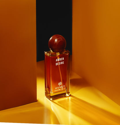 Sliding shot of Amber Desire perfume by Hvnly showcasing the top, middle and base notes of the perfume in the next frame.