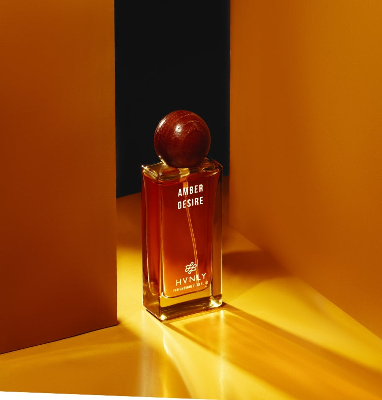 Sliding shot of Amber Desire perfume by Hvnly showcasing the top, middle and base notes of the perfume in the next frame.