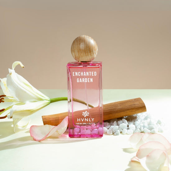 A sliding shot of Enchanted Garden perfume bottle, showcasing the top, middle and base notes of the perfume on the white background. 
