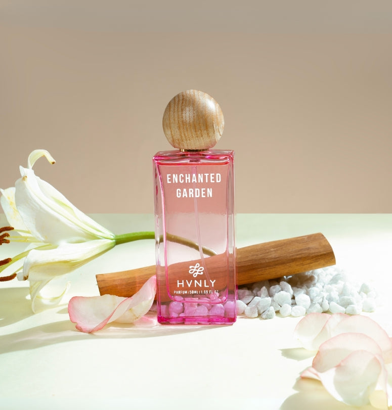 A sliding shot of Enchanted Garden perfume bottle, showcasing the top, middle and base notes of the perfume on the white background. 