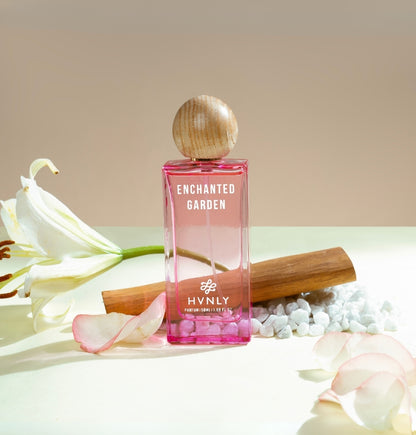 A sliding shot of Enchanted Garden perfume bottle, showcasing the top, middle and base notes of the perfume on the white background. 