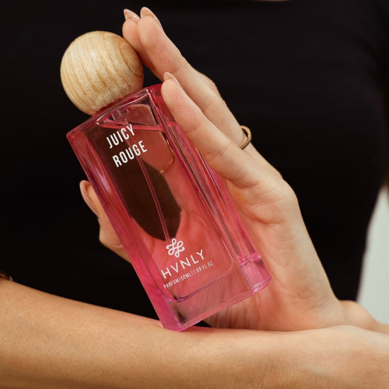 Close up shot of Juicy Rouge perfume by Hvnly portraying the design, size and aesthetics of the perfume bottle.
