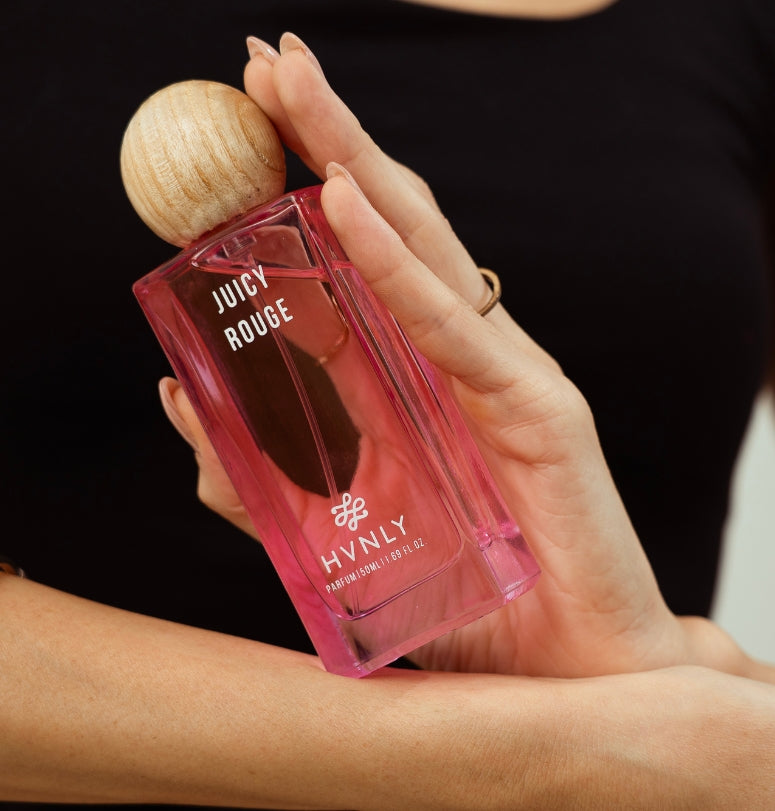 Close up shot of Juicy Rouge perfume by Hvnly portraying the design, size and aesthetics of the perfume bottle.