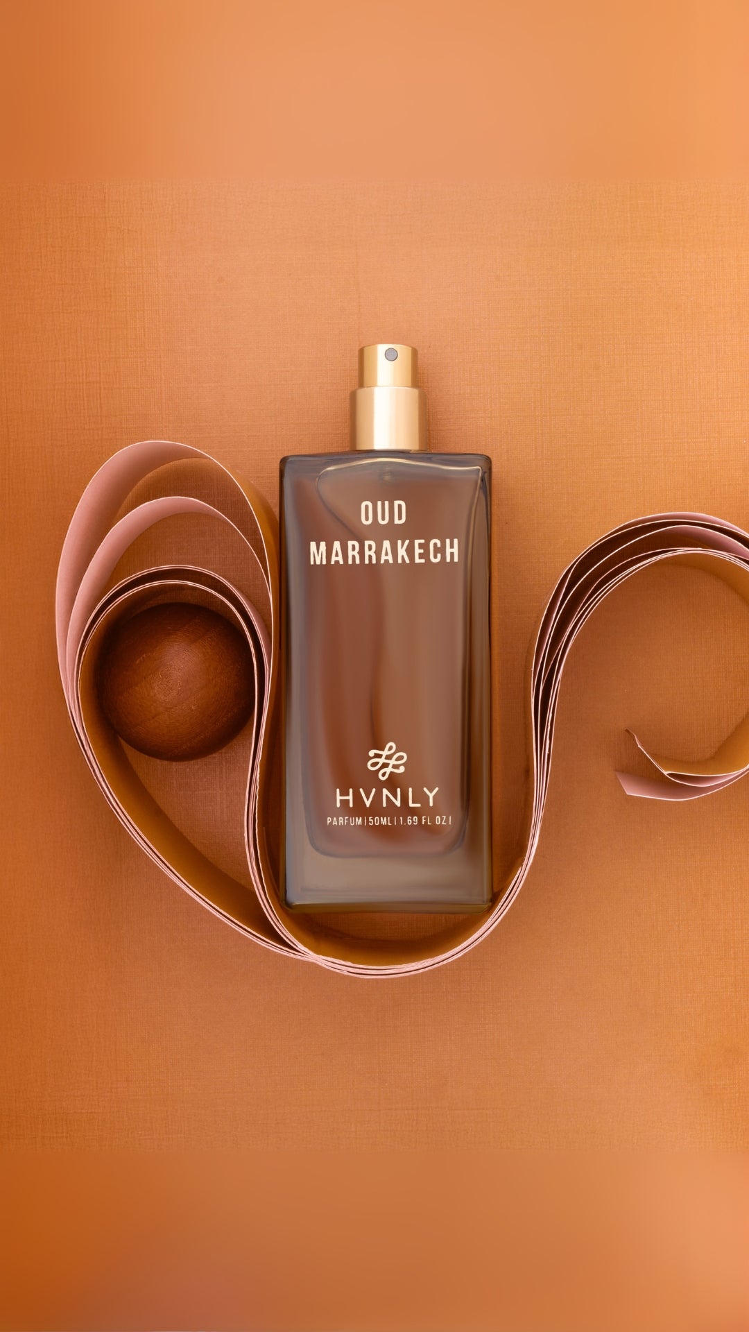 Slide shot of the Oud Marrakech perfume bottle showcasing the top, middle and base notes of the perfume.